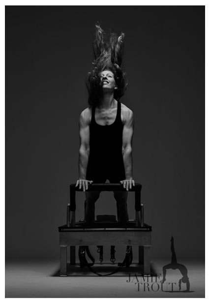 Jamie Trout demonstrating Pilates on apparatus